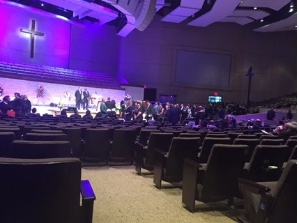 A spacious auditorium with a crowd of people